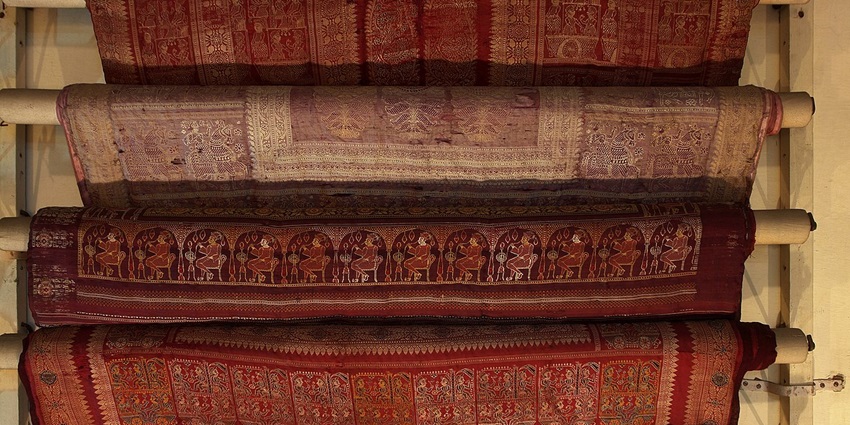 Buy traditional saris displayed at Crafts Museum, New Delhi, showcasing vibrant Indian textile heritage, one of the best things to do in Delhi for couples.