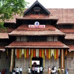 The temple entrance is decorated for the festival and a crowd is seen entering the premises.