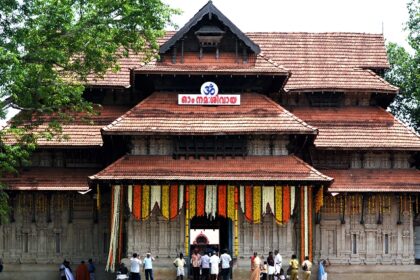 The temple entrance is decorated for the festival and a crowd is seen entering the premises.