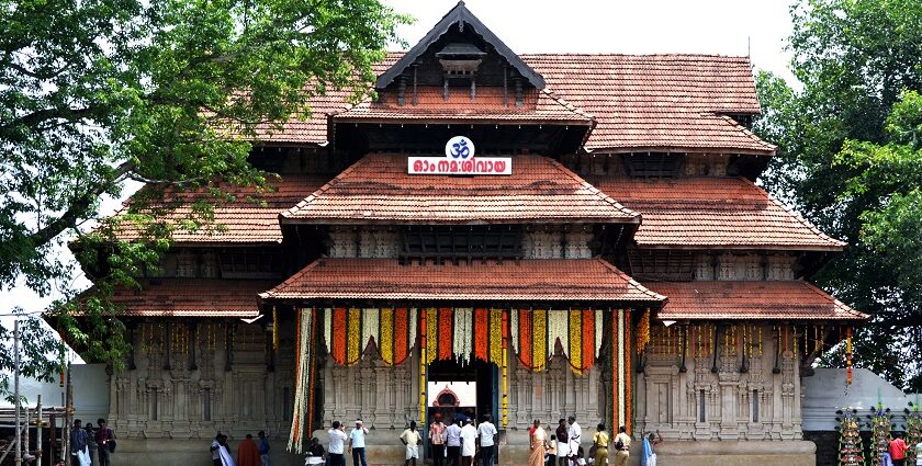 The temple entrance is decorated for the festival and a crowd is seen entering the premises.