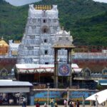 The main shrine is adorned with gold and the outside view is crowded with pilgrims.