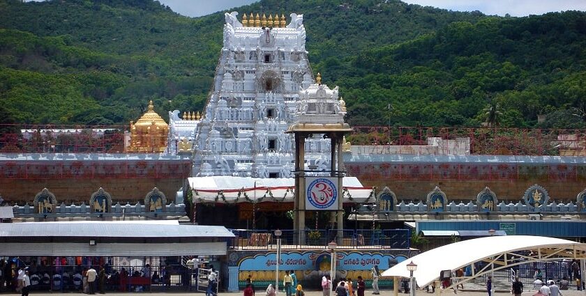 The main shrine is adorned with gold and the outside view is crowded with pilgrims.