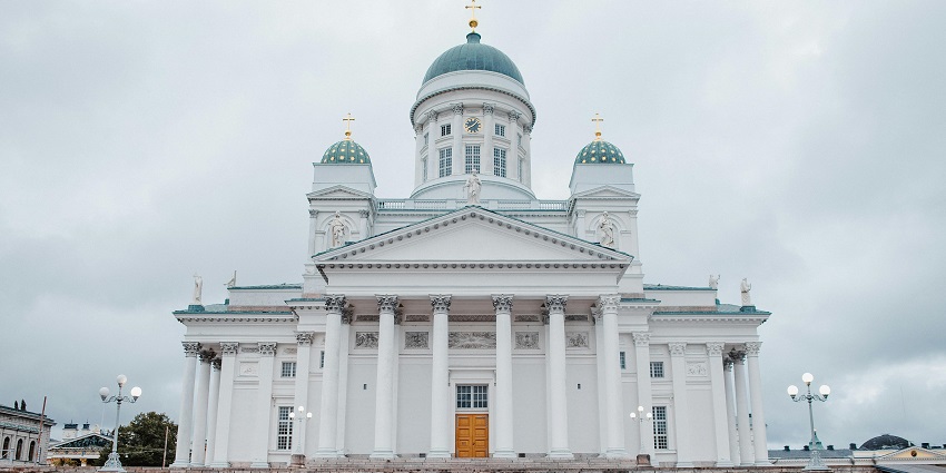 A stunning view of a white building with a blue roof during the daytime in Finland.
