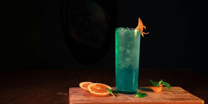 Image of a cocktail glass with fruit on top and colour drink in a club - Fire and Ice Club Kl