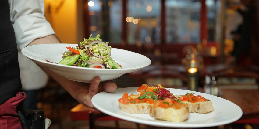 Snpoashot of the mouth watering salad and other dishes being served on the plate