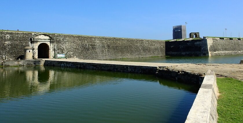 A quaint view of serene waters and majestic buildings, a famous tourist spot in Sri Lanka.