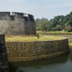 A historic view of Palakkad Fort, showcasing its impressive architecture and lush surroundings.