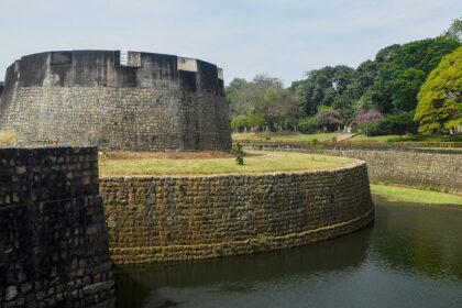 A historic view of Palakkad Fort, showcasing its impressive architecture and lush surroundings.