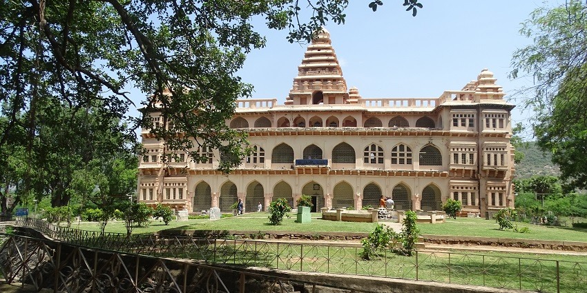 Scenic view of Chandragiri Fort with lush greenery and a clear blue sky in the background.