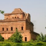 Historic Badarpur Fort, surrounded by lush greenery and ancient architectural elements.