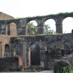 A captivating view of a fort in Goa surrounded by lush greenery during the daytime.