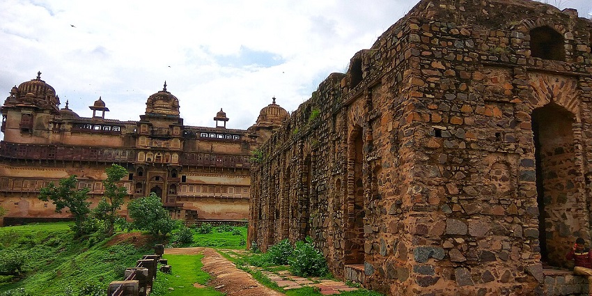 Panoramic view of fort with large stone walls, arched gateways, and surrounding landscape.