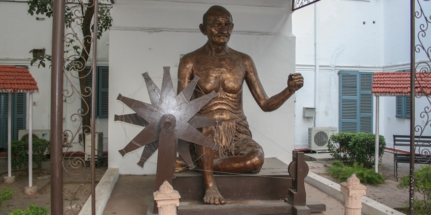 The Gandhi Smriti memorial in Delhi with statue, garden, and tranquil surroundings