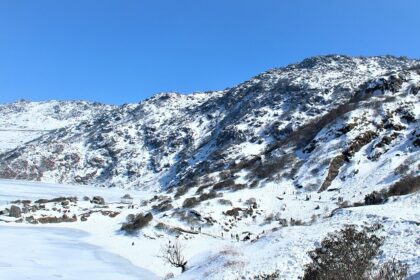 A breathtaking vista of majestic mountains covered in pristine white snow in the region.