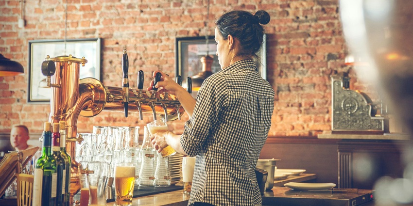 A bartender pouring drinks