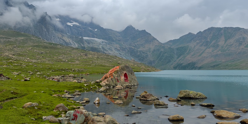 A picture of a scenic lake in Namsai with views of a mountain range in the background