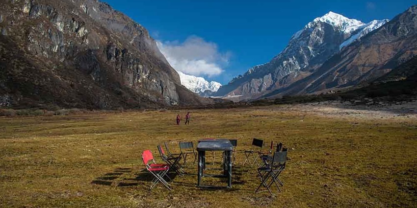 A scenic view of Goechala with mountains in the background and a roundtable in front