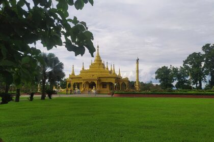 Picturesque view of Golden Pagoda, gleaming against the sky - places to visit in Namsai