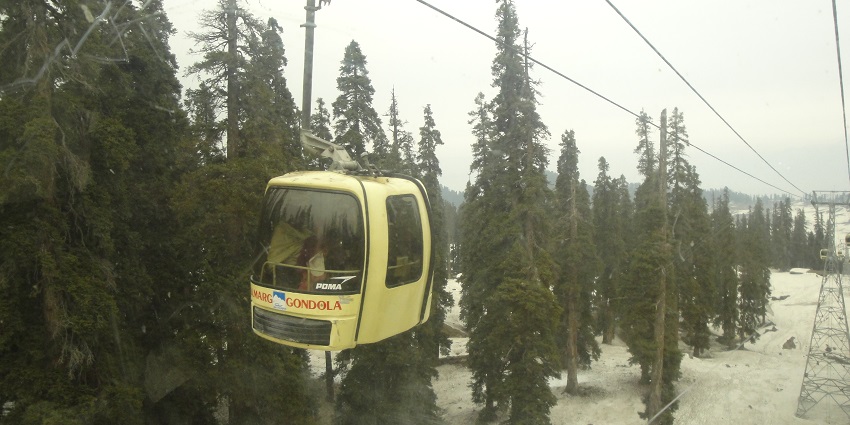 Enjoying a gondola ride amidst snow-capped mountains is one of the best things to do in Gulmarg.