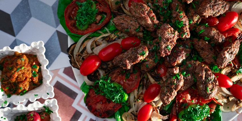 The beautiful picture of a meat dish on the table and platter—Best food in kashmir