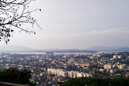 A breathtaking aerial view of Guwahati with a lot of houses and trees during the daytime.