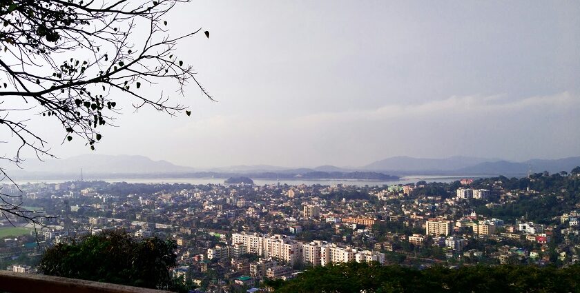 A breathtaking aerial view of Guwahati with a lot of houses and trees during the daytime.