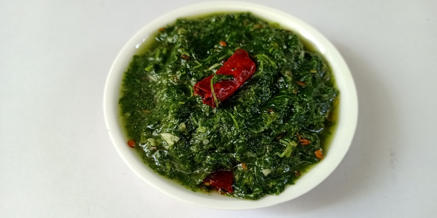Beautiful delicious snapshot of the freshly cooked Saag dish on the table–Food in Kashmir