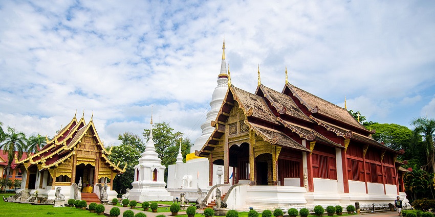 Grand hall of Wat Phra Singh in Chiang Mai, with intricate carvings and golden decor.