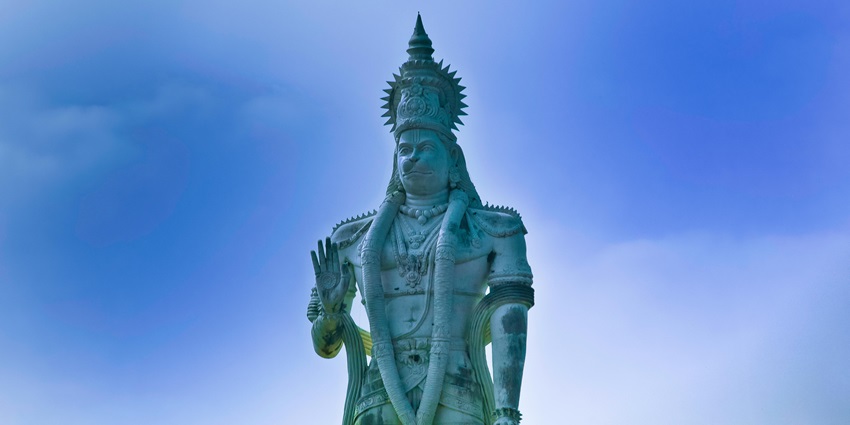 Hanuman statue, highlighting the deity's iconic pose and traditional adornments.