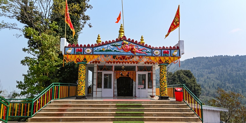 A frontal view of a Hanuman temple perched upon the hills of Sikkim with stunning views