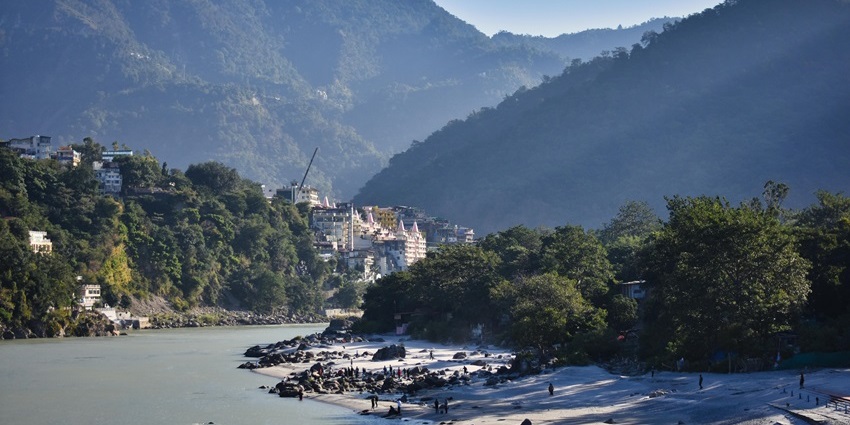 Beautiful view of the Ganga river, with houses and greenery at its shore