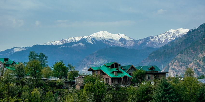 Picturesque view of the village cottages overlooking the snow capped hills far ahead