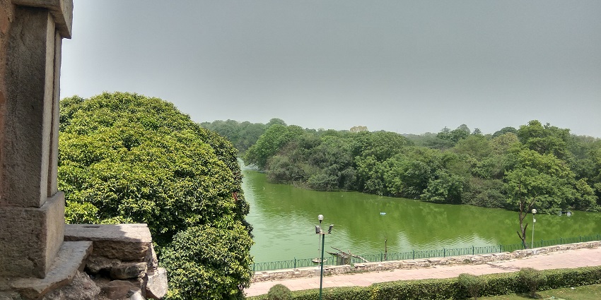Panoramic view of the green lake amidst the beautiful garden from the Hauz Khas park