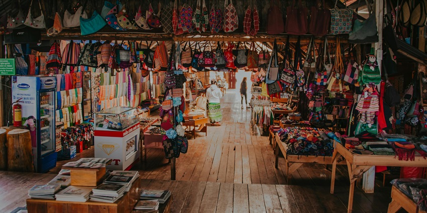 Picturesque view of a scenic market full of beautiful hand-woven products and books.