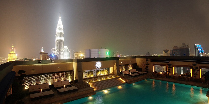 A beautiful rooftop bar with a pool in the middl