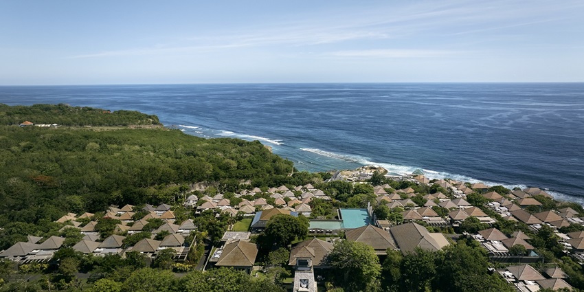 An aerial picture of Bali with views of lush greenery and the vast sea around the coast