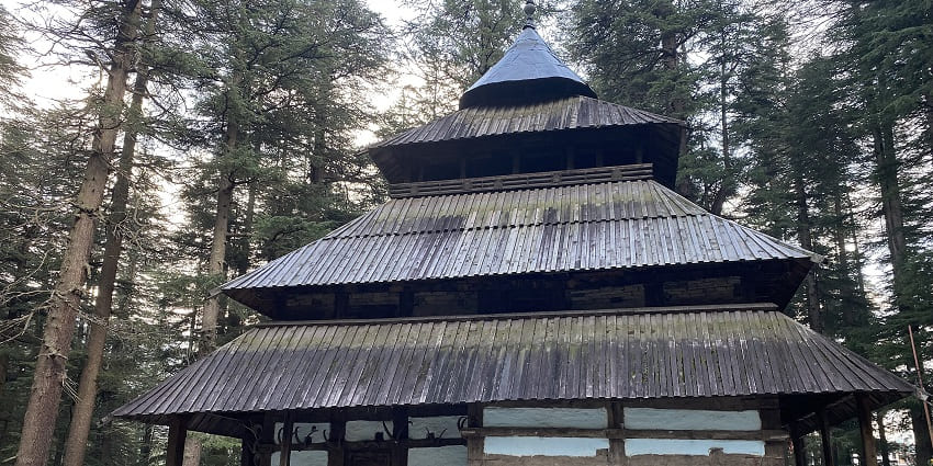 Image of the Hidimba Devi temple, surrounded by lush greenery