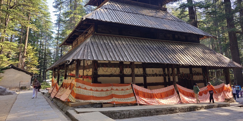 A scenic view of Hidimba Devi Temple surrounded lush greenery - Places to visit in Kullu Manali in December.