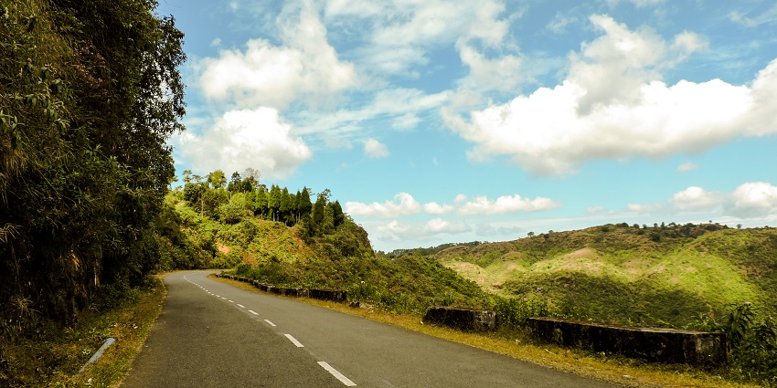 The scene views from a road that passes through the green lush hills of Shillong