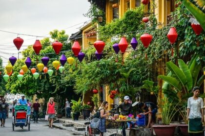 Beautiful image the street of Hoi An laden with the lamps and Flowers– Hoi An nightlife