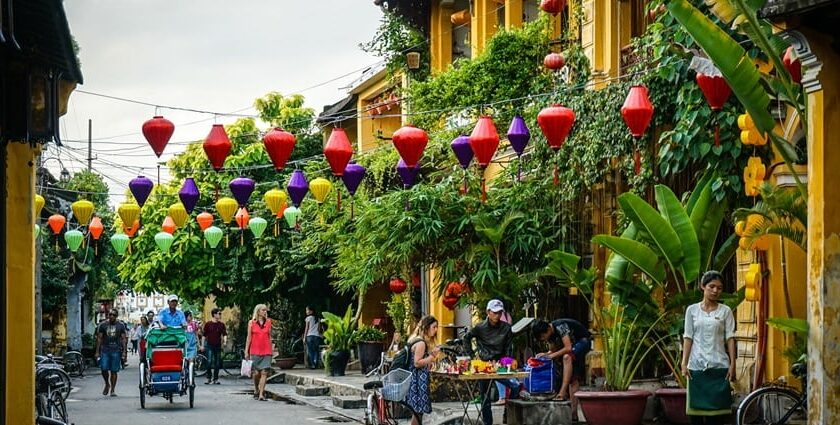 Beautiful image the street of Hoi An laden with the lamps and Flowers– Hoi An nightlife