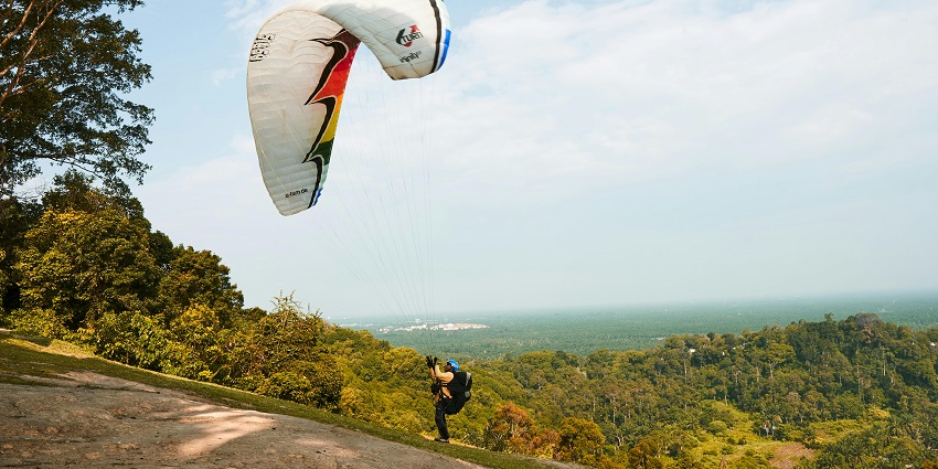 Man preparing for takeoff with a backdrop of open skies - Patnitop is one of the best spots for paragliding