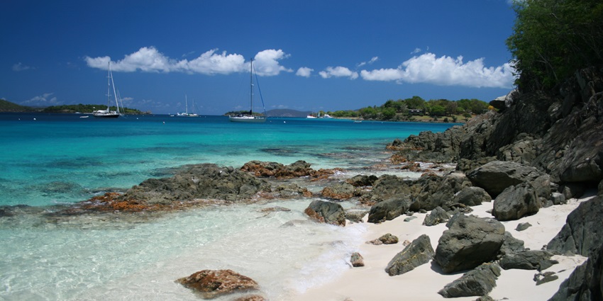 Romantic Salmon Bay Honeymoon Beach with golden sand, gentle waves, and clear skies.
