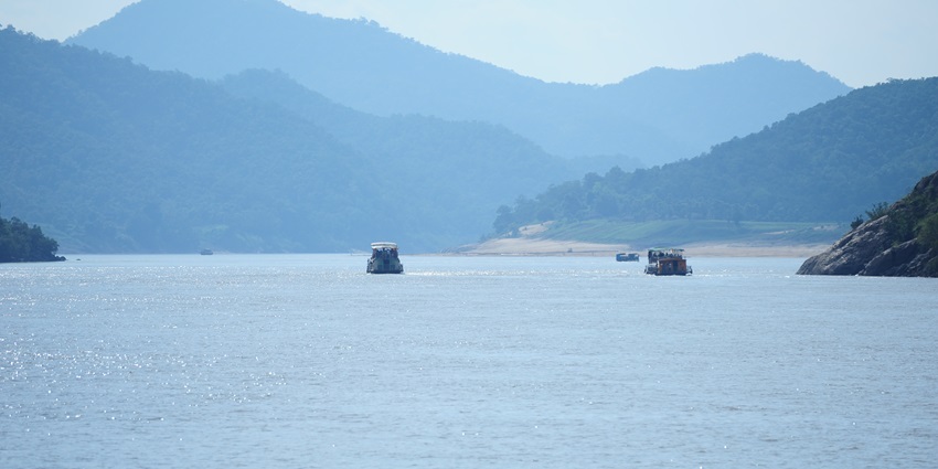 A boat sailing on the serene waters of Hope Island, situated on the coast of Kakinada.