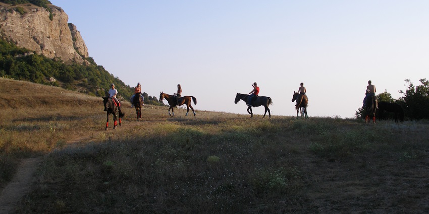 People riding horses in twilight time