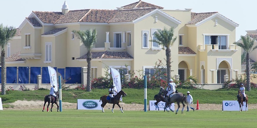 A picture of the Polo Club, Dubai with various participants engaging in horseriding