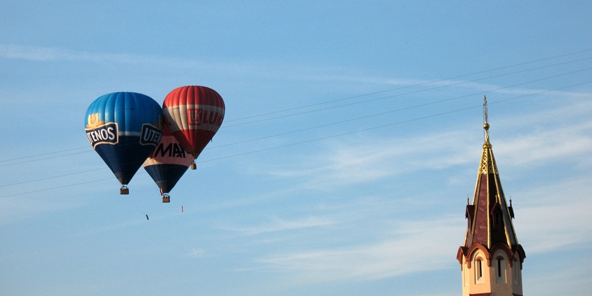 Hot air balloons floating in the air, people enjoying one of the best things to do in Dubai