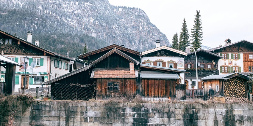 beautiful snapshot of a hotel surrounded by the forest and snowy hills