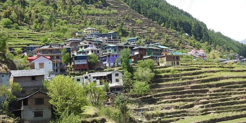 A picture of a beautiful landscape with green hills and houses