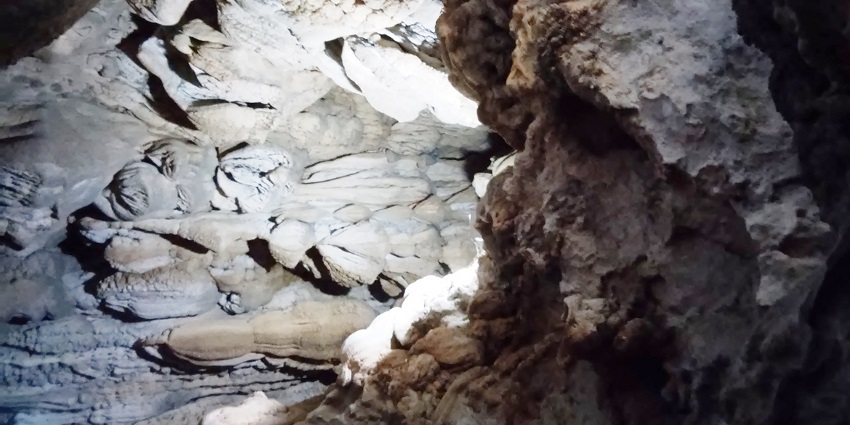 A picture of a limestone cave in Meghalaya taken from the inside with sunlight coming from the cave entrance